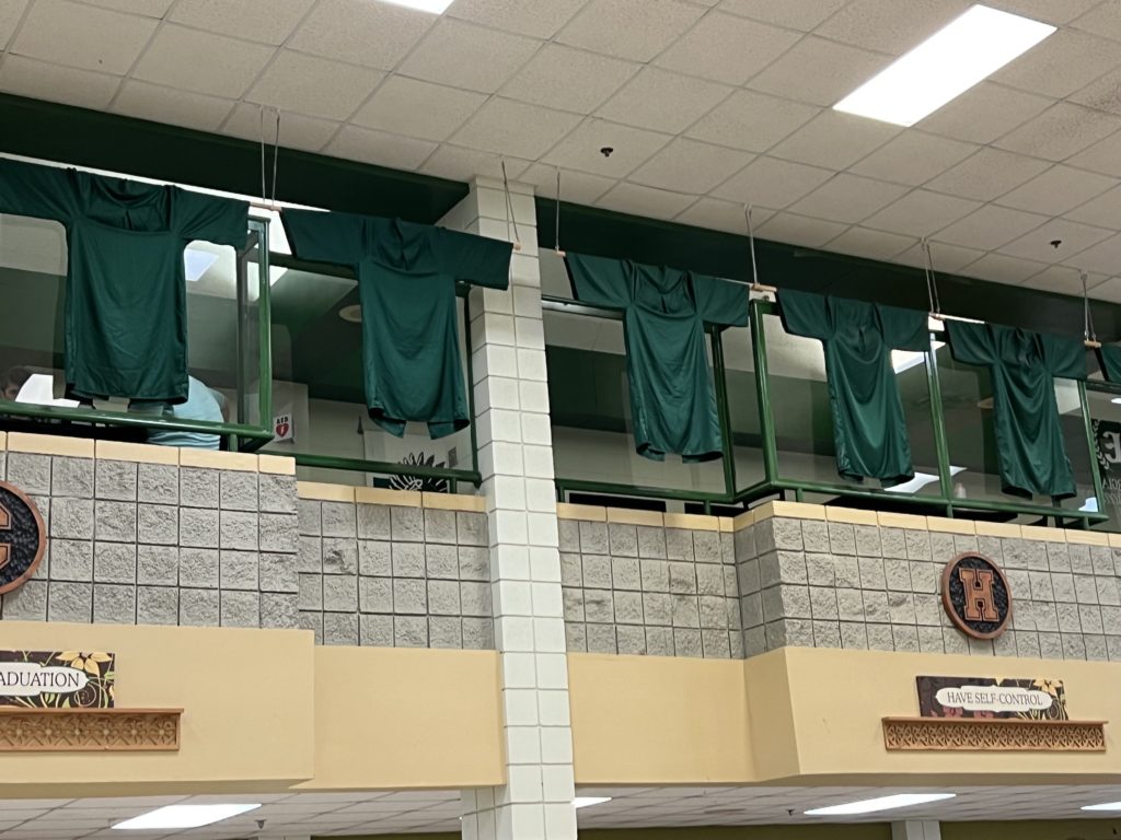 Principal Gina Linder’s graduation gowns signed by students hang from the cafeteria rafters at Murray County High School in Chatsworth, GA.
