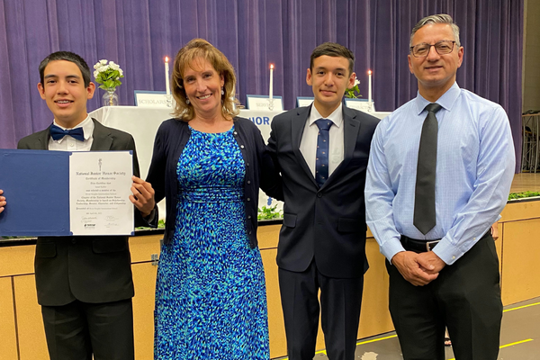 Left to right: Israel Kaller, Principal Teri Dudley, Nathan Kaller, and Superintendent Sam Buenrostro at River Heights’ NJHS induction. 
