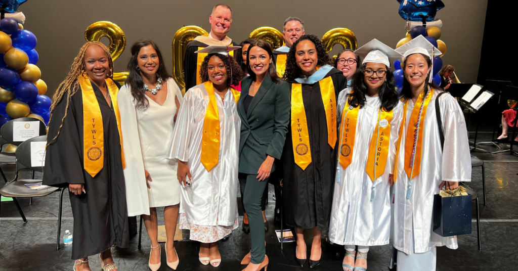 Principal Allison Persad, second from left, with students, staff, and Rep. Alexandria Ocasio-Cortez, center, a keynote speaker at graduation this past year. The school is located in Rep. Ocasio-Cortez's district.