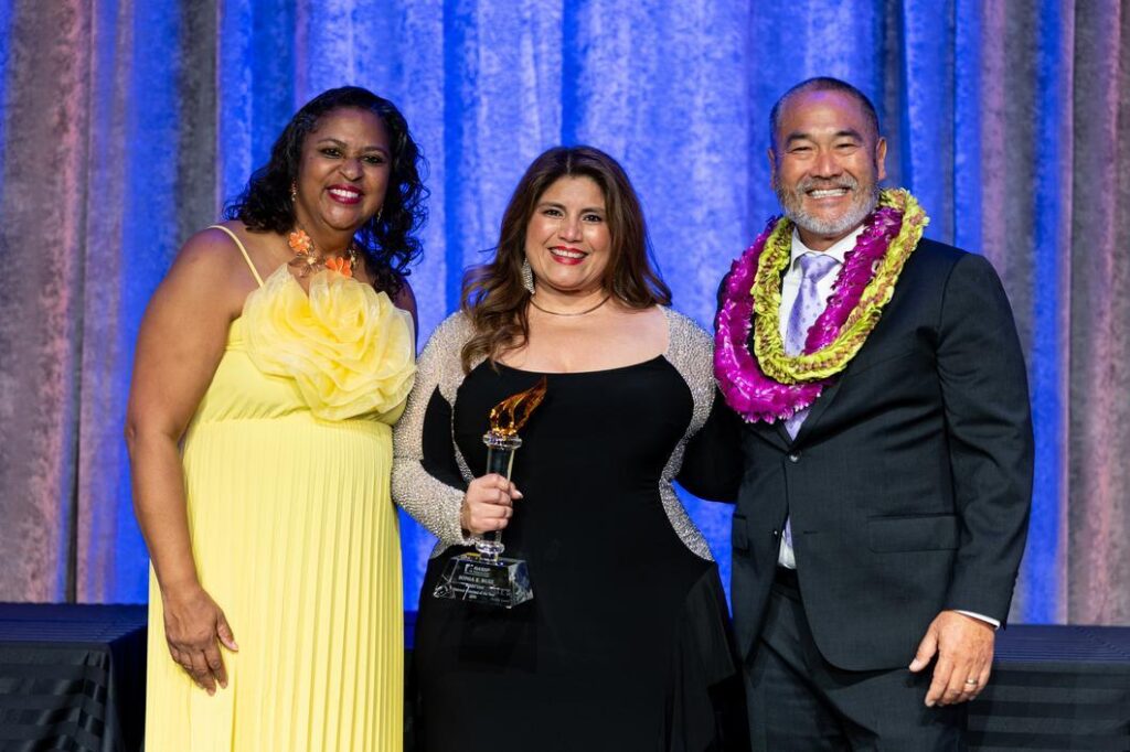 The 2026 National Middle Level Principal of the Year Sonia Ruiz stands with NASSP Board President Evelyn Edney, left, and NASSP CEO Ronn Nozoe, right.